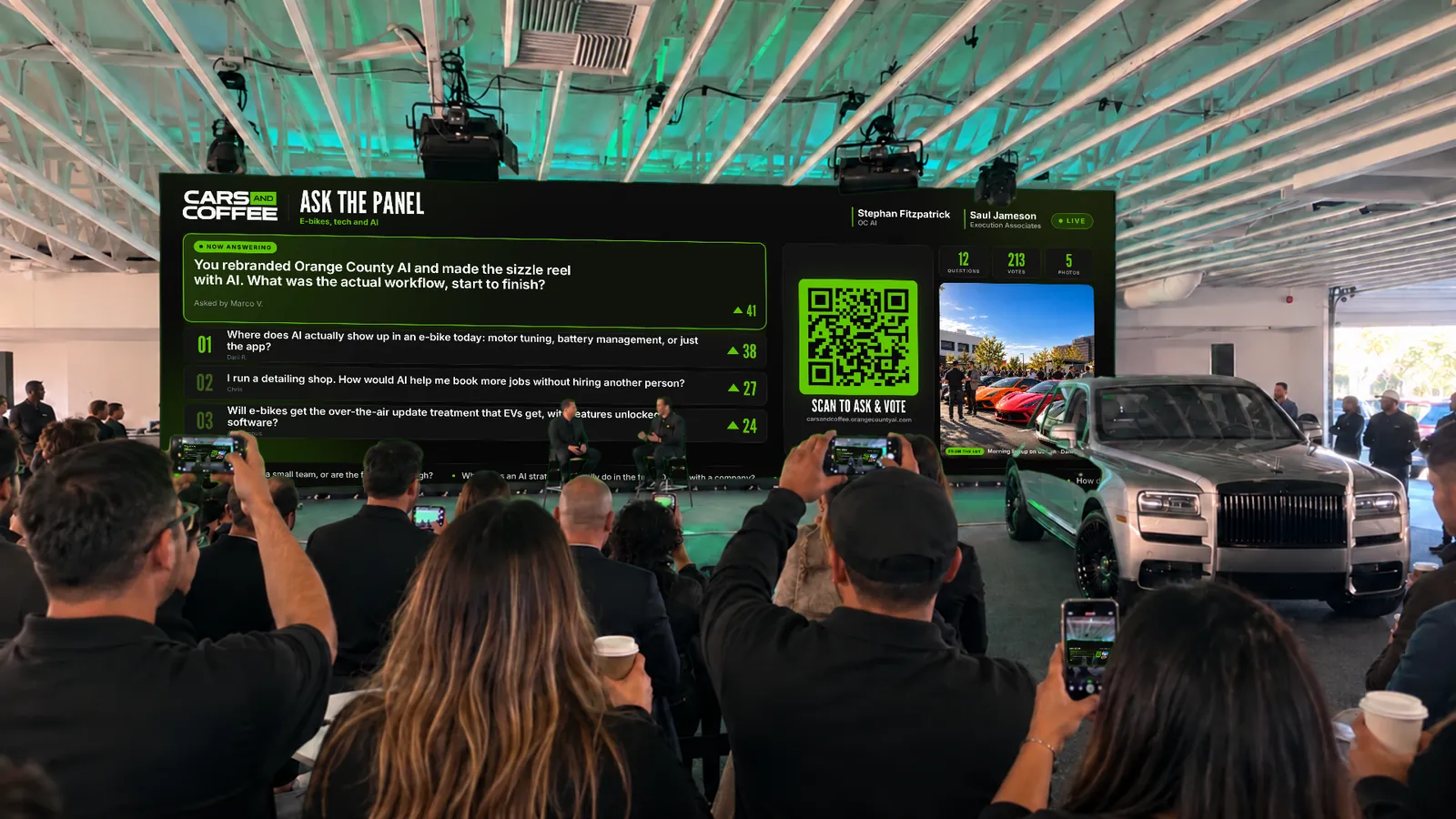 A crowd facing a wide LED wall showing the live question board, phones raised